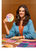 Deh Martini seated at a table with Color Craft color analysis materials, holding a professional color wheel