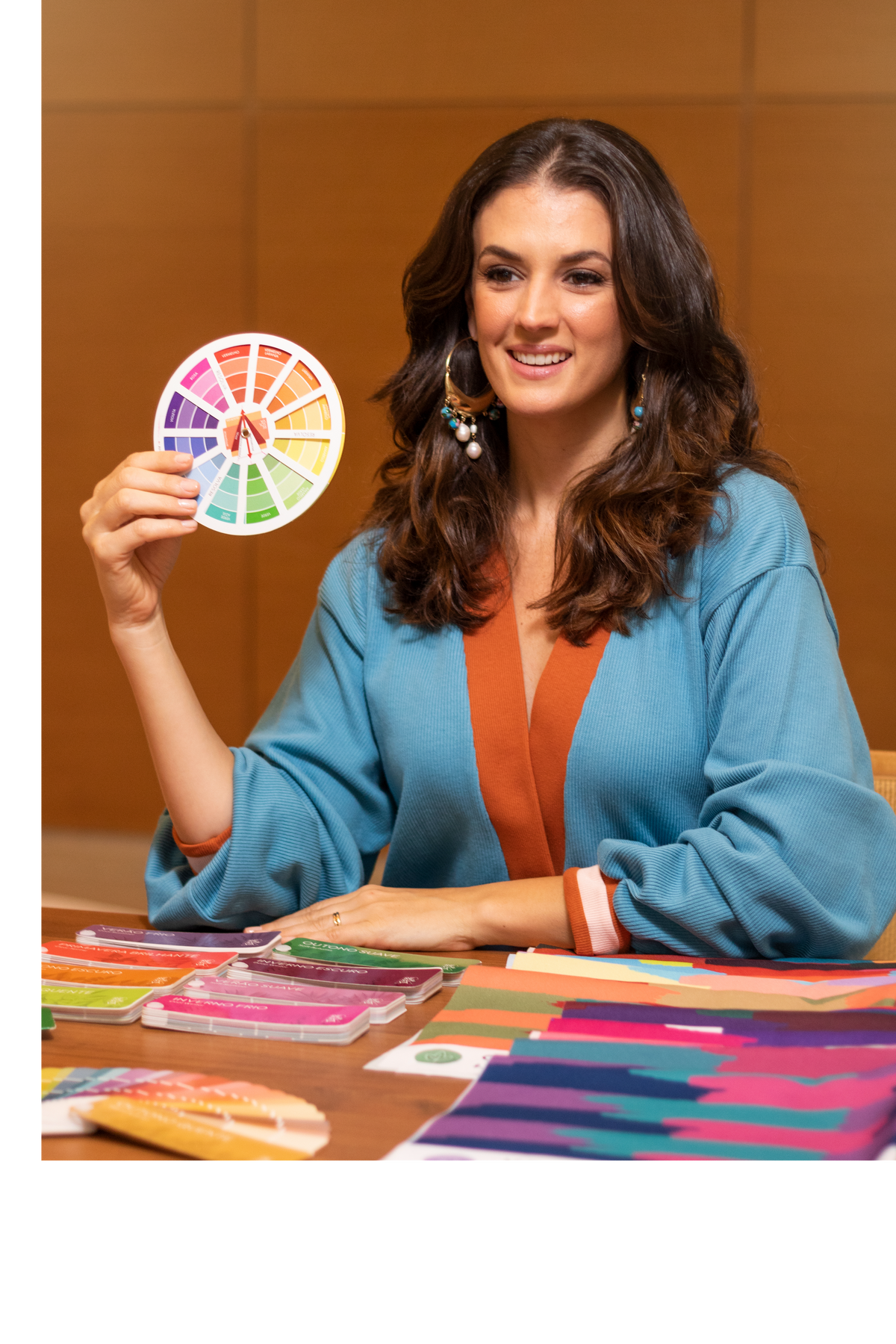 Deh Martini seated at a table with Color Craft color analysis materials, holding a professional color wheel